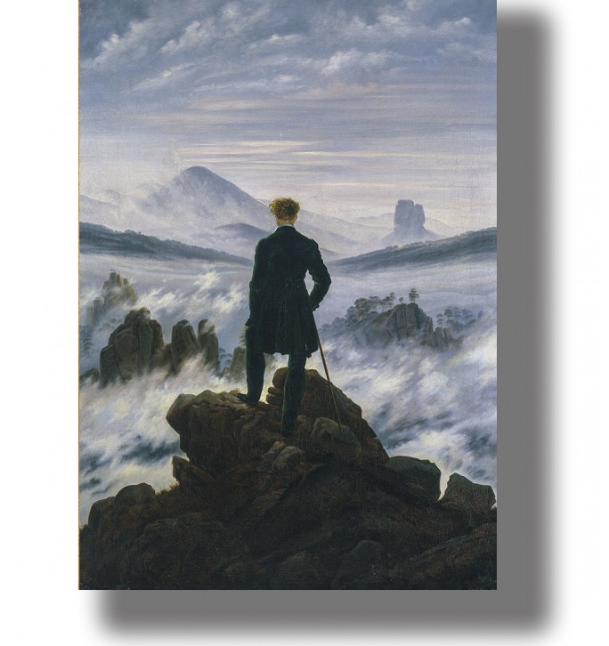 A lone figure on a rock looking over misty mountains and a cloudy sky.
