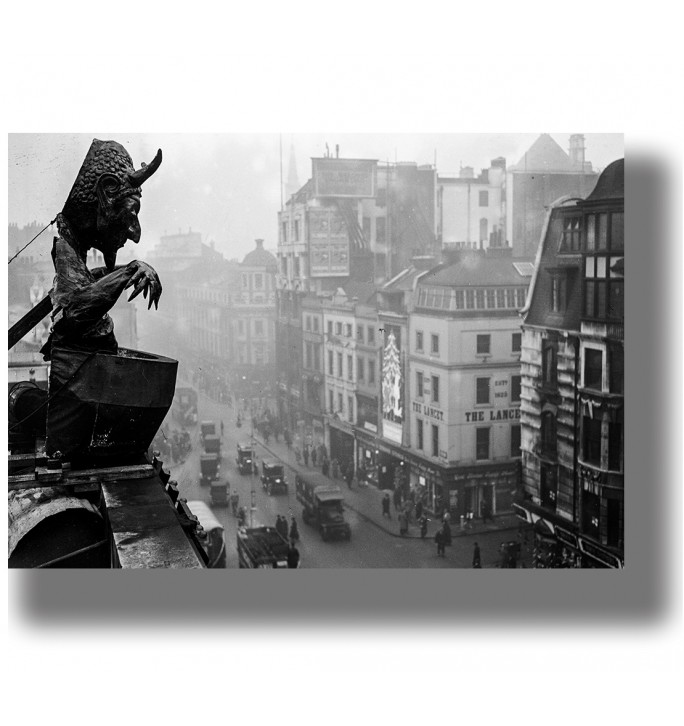 Black and white photo of a gargoyle above a London street with old buildings and cars below.