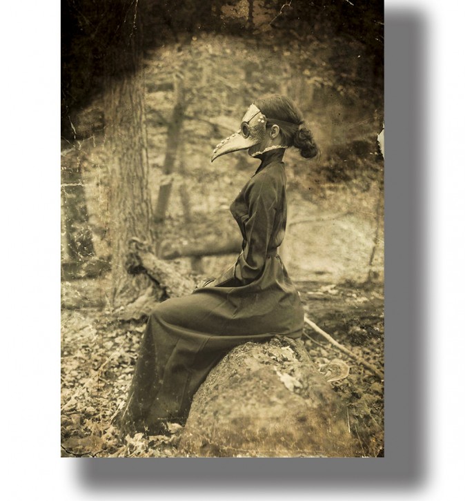 Vintage-style image of a person in a plague doctor mask sitting on a rock in the woods.