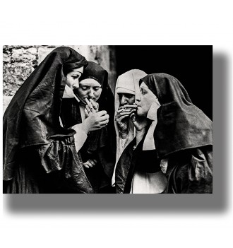 Vintage black and white photo of four nuns lighting cigarettes together.