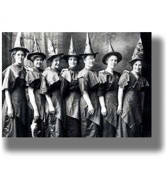 Old group portrait of women wearing pointed hats and similar dark dresses.