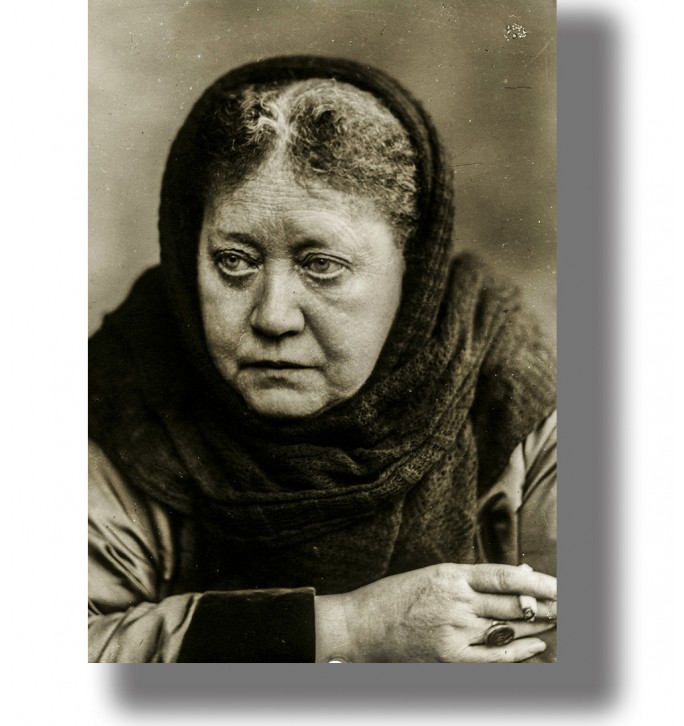 Vintage black and white portrait of Helena Blavatsky wearing a dark headscarf and looking away from the camera.