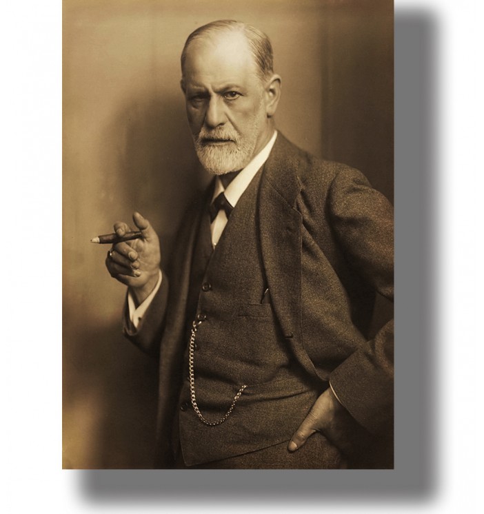 Vintage photographic portrait of Sigmund Freud in a suit holding a cigar and looking directly at the camera.