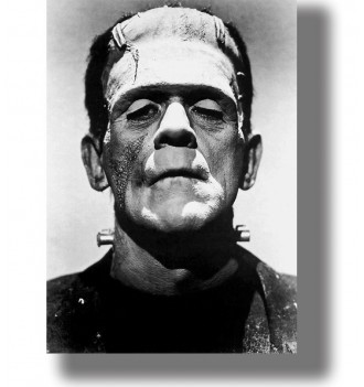 Black and white close-up of Frankenstein’s monster with a flat head, heavy features and bolts at the neck.