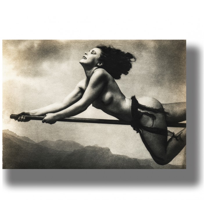 Vintage photograph of a nude witch flying on a broomstick in a witch sabbath scene.