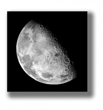 Black and white photograph of the Moon showing its cratered lunar surface against a deep black background.