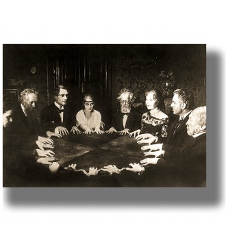 Vintage sepia photo of people gathered around a table during a séance in a dark interior.