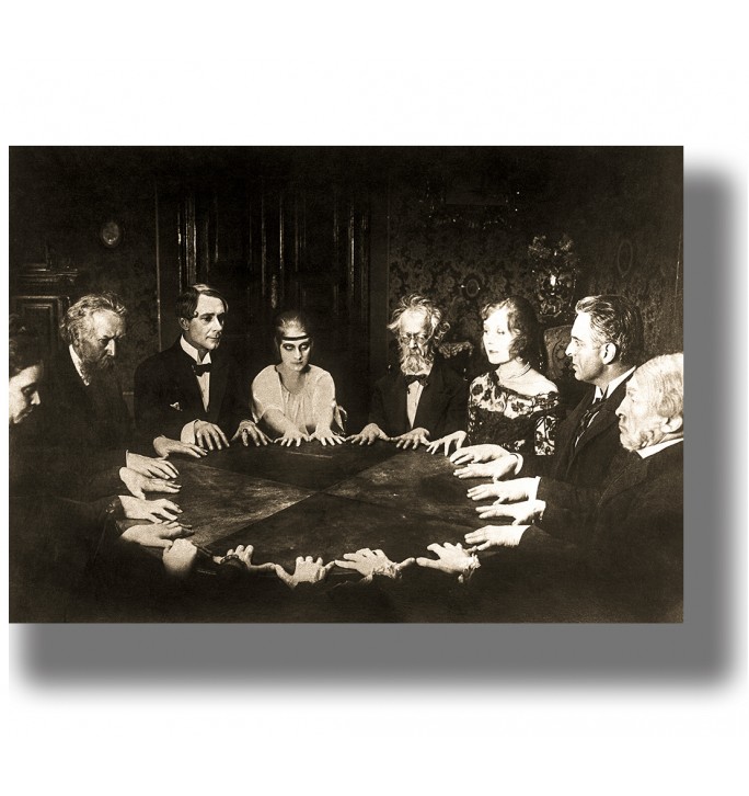 Vintage sepia photo of people gathered around a table during a séance in a dark interior.