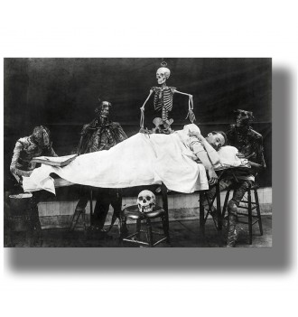 Antique black and white photo of skeletons and anatomical figures around a person lying on a table.