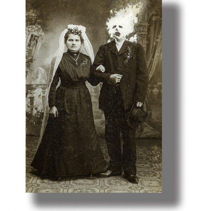 Vintage wedding photo of a bride standing beside a groom whose head appears to be on fire.