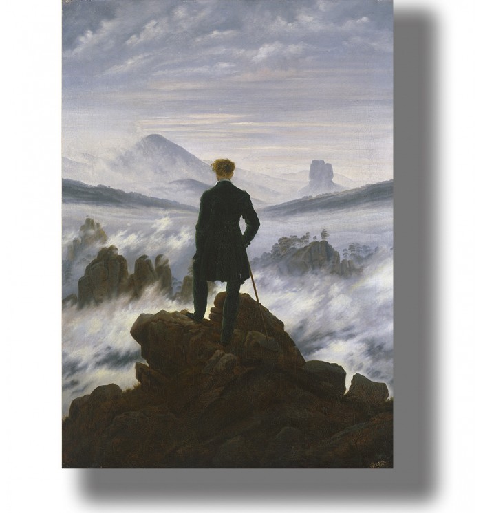 A lone figure on a rock looking over misty mountains and a cloudy sky.